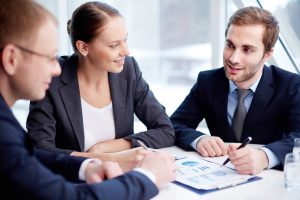 Business professionals discussing financial charts and captive finance strategies in a meeting