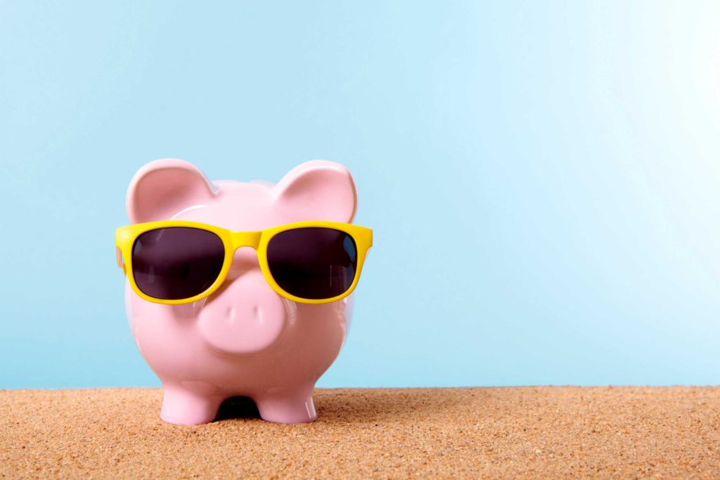 Piggy bank wearing yellow sunglasses representing a fun take on what is a pay pig side hustle